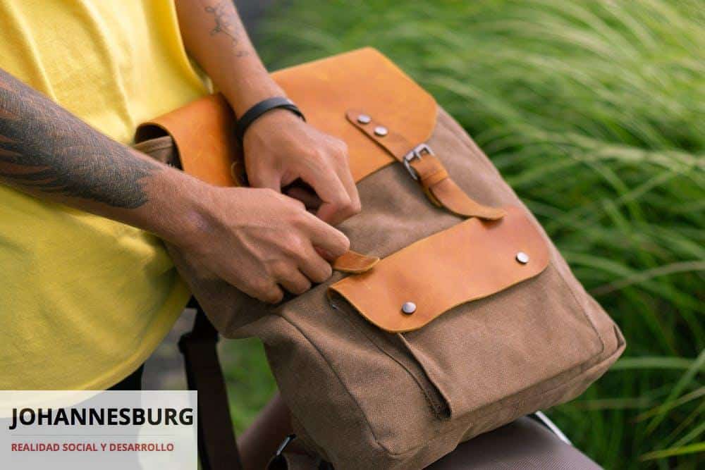 Person Holding a Brown Backpack