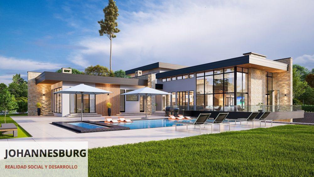a modern house with a pool and lounge chairs